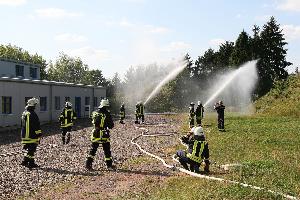 Bild: Bekämpfung des Flächenbrandes im Umfeld der Industriehalle